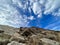 Blue skies and dramatic clouds over the lunar landscapes of Paros, Greece — EUROPE